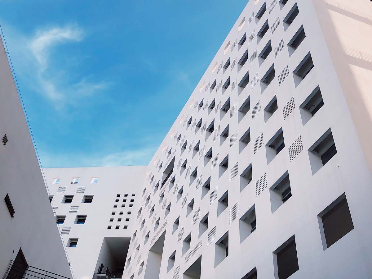 office building low-angle photography of white building city
